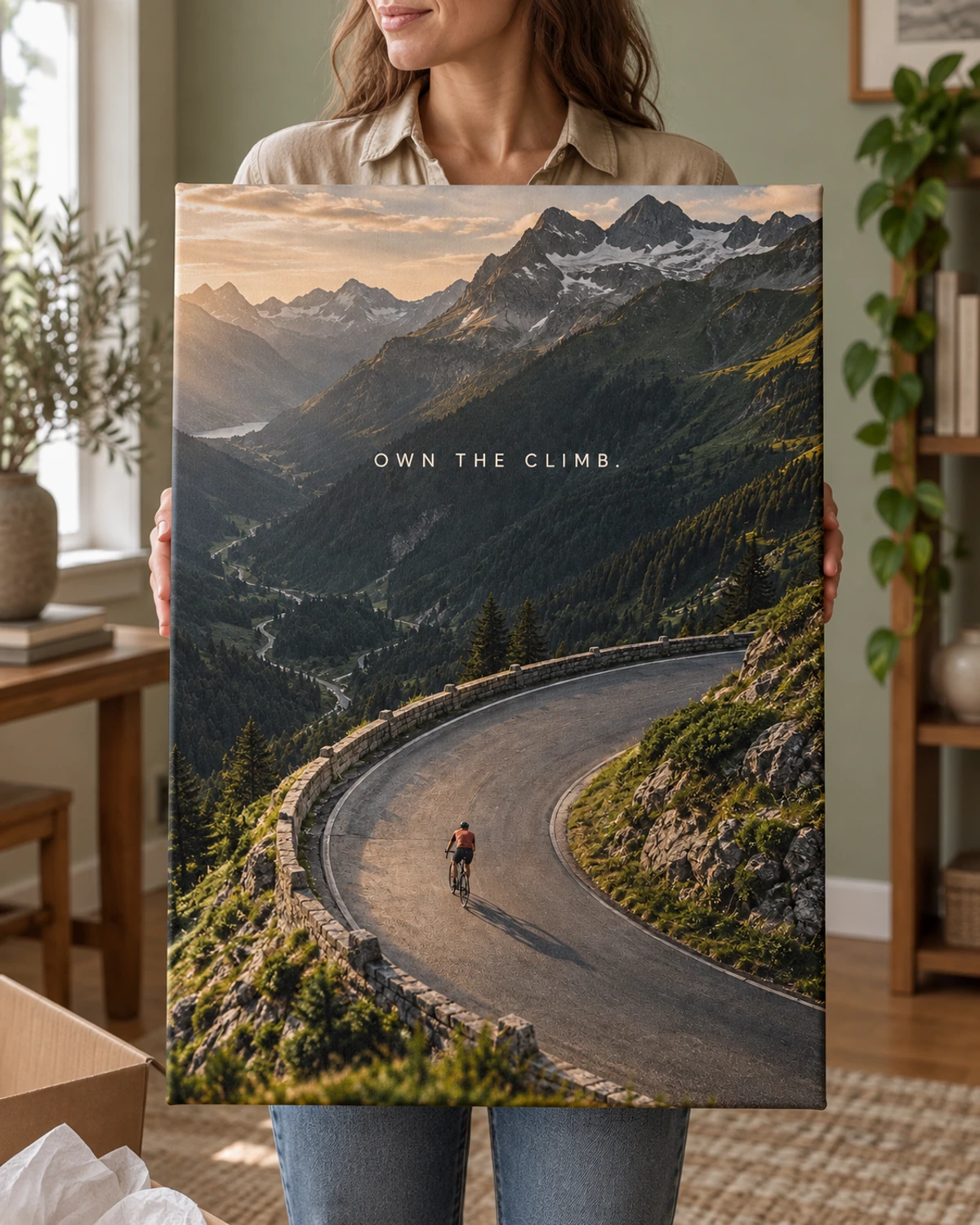 Own The Climb stretched canvas held after unpacking in a naturally lit home