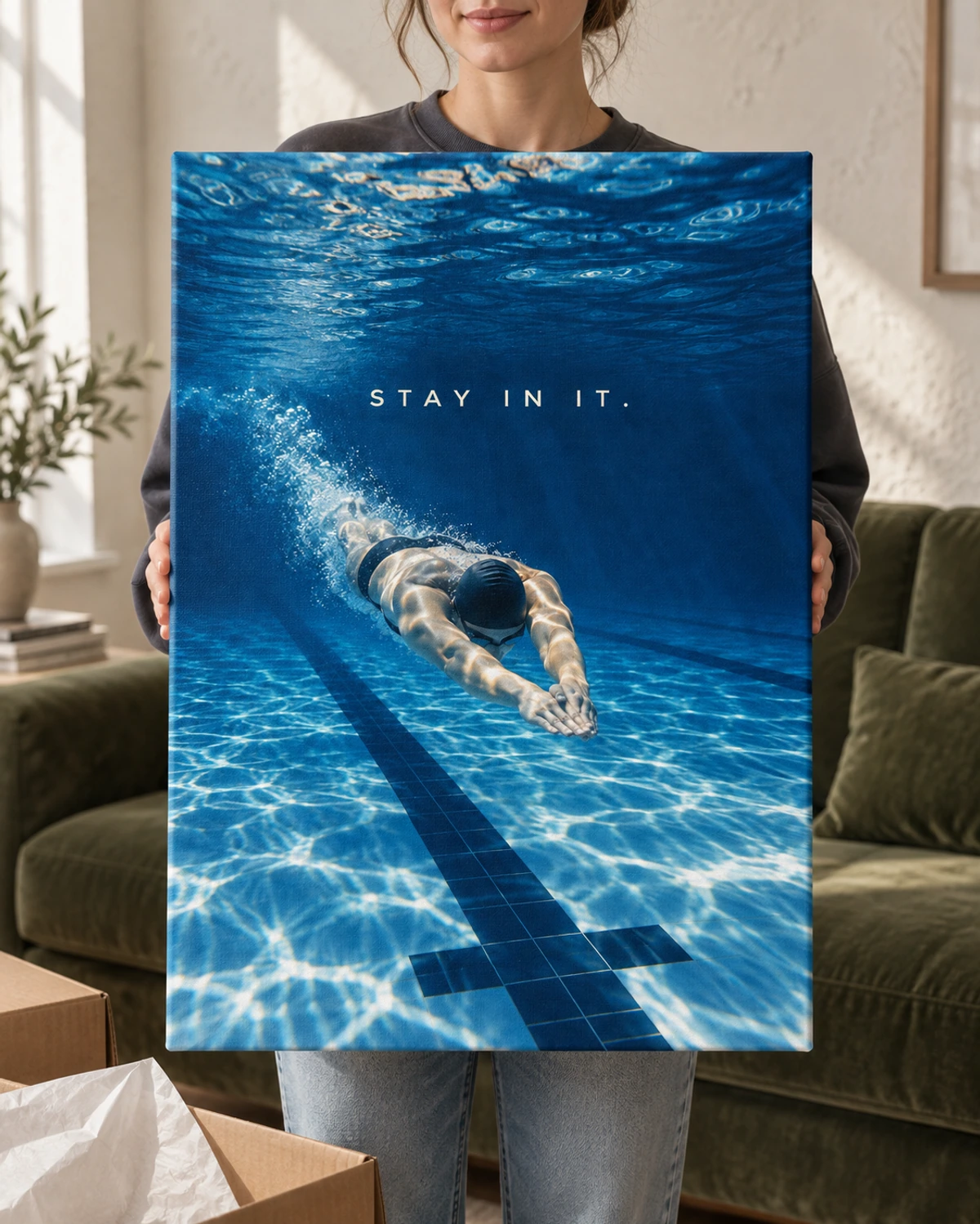 Stay In It stretched canvas held after unpacking in a naturally lit home